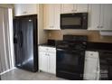 Well-appointed kitchen with black appliances and white cabinetry for ample storage at 331 Eastwood Dr, Salisbury, NC 28146