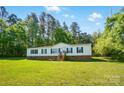 Inviting one-story home with lush green lawn and mature trees, accented by green shutters and a welcoming entrance at 3678 Old Camden Hwy, Heath Springs, SC 29058
