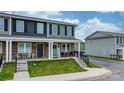 Well-maintained townhome exterior with stone accents, covered porch, and manicured lawn at 3722 Windy Pine Nw Ln, Hickory, NC 28601