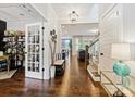 Open foyer with hardwood floors and views into the living spaces, accented by a stylish bench and decor at 423 Sensibility Cir, Fort Mill, SC 29708