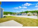 Backyard featuring a well-maintained lawn surrounded by a white picket fence and some trees at 5014 Fandango Rd, York, SC 29745