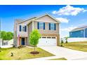 Two-story home featuring a brick-accented front, garage, blue shutters, and green front lawn at 5014 Fandango Rd, York, SC 29745