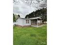 A well-kept home featuring vinyl siding and a covered porch on a green lawn at 51 Kings Dr, Taylorsville, NC 28681