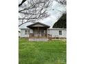 Inviting single-level home boasting a cozy covered porch and landscaped front yard at 51 Kings Dr, Taylorsville, NC 28681