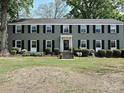 Traditional brick home with black shutters, manicured landscaping, and a welcoming entrance at 557 Wakefield Dr # A, Charlotte, NC 28209