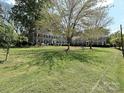 Expansive front yard with mature trees shading the well-maintained lawn at 557 Wakefield Dr # A, Charlotte, NC 28209