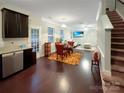 Open-concept living area with dining table, stainless appliances, hardwood floors, and a seamless flow for entertaining at 620 Millstream Dr, Rock Hill, SC 29732