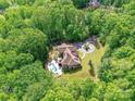 Expansive aerial view of a secluded home with pool, surrounded by dense green forest at 633 Elmhurst Dr, Fort Mill, SC 29715