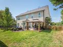 Large backyard featuring a spacious deck with a pergola, outdoor dining furniture, and a seating area with plush cushions at 653 Gable Oaks Nw Ln, Concord, NC 28027
