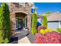 Inviting front porch with stone archway, lush greenery, and stylish decor at 826 Coralbell Way, Fort Mill, SC 29708