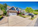 Beautiful home featuring a spacious driveway, well-maintained lawn, and colorful landscaping at 826 Coralbell Way, Fort Mill, SC 29708