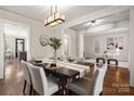 Elegant dining room with stylish light fixture and hardwood floors at 10102 Tolleson Ave, Charlotte, NC 28277