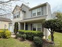 Well-maintained two-story home with a cozy front porch and manicured shrubs at 1110 Valley St, Statesville, NC 28677