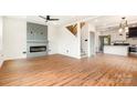 Open-concept living room with wood floors, a decorative fireplace, and an adjacent kitchen area for easy entertaining at 1314 Eddie St, Gastonia, NC 28054