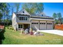 Beautiful two-story home with a well-manicured lawn and a three-car garage at 139 Poplar Grove Rd, Mooresville, NC 28117