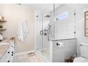 Contemporary bathroom with walk-in shower, white marble tile, and modern fixtures at 141 Rose St, Mooresville, NC 28117