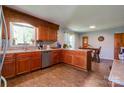 Well-lit kitchen with wood cabinets, stainless steel appliances, and a cozy dining area at 1410 Beverly Ave, Shelby, NC 28152