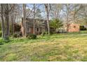 Charming brick home with mature trees and lush lawn on a sunny day, offering curb appeal and a peaceful setting at 1620 Edgefield Ave, Gastonia, NC 28052