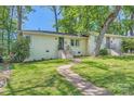 Charming brick home with well-manicured lawn, mature trees, and inviting walkway leading to the front door at 1702 Herrin Ave, Charlotte, NC 28205