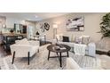 Stylish living room with modern furniture, neutral tones, hardwood floors, and an open floor plan at 1702 Herrin Ave, Charlotte, NC 28205