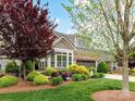 Charming home exterior featuring manicured landscaping and a two-car garage at 1805 Axholme Ct, Waxhaw, NC 28173