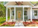 Close-up of a home's front porch, featuring a decorative door and pillars at 208 Spinners Dr, Cherryville, NC 28021