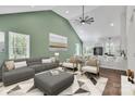Bright living room featuring vaulted ceilings, modern decor, and an open-concept design to the kitchen at 208 Spinners Dr, Cherryville, NC 28021