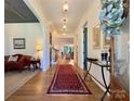 Bright and airy foyer featuring hardwood floors, elegant lighting, and a view into the living spaces at 2309 Pinckney Ave, Charlotte, NC 28205