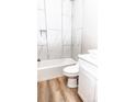 Modern bathroom with tile surround, new vanity, and updated fixtures at 2350 14Th Street Ne Ct, Hickory, NC 28601