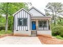 Charming new build home with a striking blue door, white siding, and black trim nestled in a leafy setting at 2350 14Th Street Ne Ct, Hickory, NC 28601