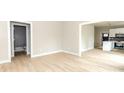 Bright living room with sleek wood floors, open floor plan leading to a modern kitchen and a bathroom at 2350 14Th Street Ne Ct, Hickory, NC 28601