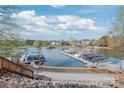 Picturesque lakeside docks with multiple boats, nestled in a serene waterfront community at 255 Fernbrook Dr, Mooresville, NC 28117