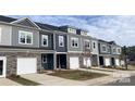 New townhomes with stone accents, garages, modern windows, and professional landscaping at 2579 Ruby Dixon Crossing Dr # 12, Gastonia, NC 28056