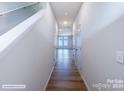 Bright hallway with hardwood floors, leading to bedrooms, and freshly painted walls at 2579 Ruby Dixon Crossing Dr # 12, Gastonia, NC 28056