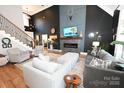 Expansive living room with soaring ceilings, modern fireplace, stylish furnishings, and abundant natural light at 2757 Trent Ne Dr, Conover, NC 28613