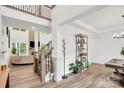Welcoming entryway featuring wood floors, a staircase with iron railings, and an open-concept design at 3081 Montreaux Valley Dr, Fort Mill, SC 29707