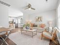 Bright living room featuring hardwood floors, a neutral color scheme, and stylish modern furniture at 415 French St, Charlotte, NC 28216