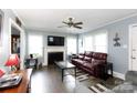 Bright living room with hardwood floors, a fireplace, and a comfortable leather sofa at 427 Spencer St, Rock Hill, SC 29730