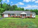 Charming brick home featuring a well-manicured lawn and inviting curb appeal at 4462 Flat Creek Rd, Heath Springs, SC 29058