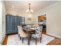 Cozy dining room with a large table, decorative cabinet and elegant furnishings at 6419 Gilead Rd, Huntersville, NC 28078