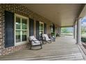 Inviting front porch with rocking chairs, ideal for relaxing and enjoying the outdoor view at 6419 Gilead Rd, Huntersville, NC 28078