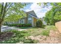 Exterior view of townhome and lawn featuring lush greenery and an inviting outdoor space at 643 Brickdust Ct, Fort Mill, SC 29708