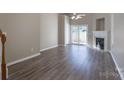 Bright living room featuring hardwood floors, a fireplace, and sliding glass doors to outdoor space at 643 Brickdust Ct, Fort Mill, SC 29708