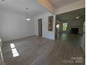 Open concept living room featuring hardwood floors, natural light, and seamless flow to other spaces at 6846 Beverly Springs Dr, Charlotte, NC 28270