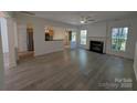 Spacious living room with fireplace, ceiling fan, open layout and easy access to kitchen at 6846 Beverly Springs Dr, Charlotte, NC 28270