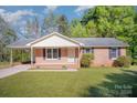 Charming brick ranch home with a covered carport, inviting curb appeal, and landscaped front yard at 700 Fine Wright Ave, York, SC 29745