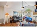 Inviting living room with vaulted ceilings, large windows, and a cozy seating area at 7444 Hurstbourne Green Dr, Charlotte, NC 28277
