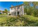 Charming two-story home boasts a well-maintained lawn, complemented by mature trees for added curb appeal at 8719 Sweet Sage Ln, Charlotte, NC 28227