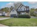 Inviting two-story home with a lush green lawn and a convenient two-car garage at 908 Carole Summey Dr, Dallas, NC 28034