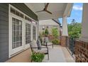 Inviting front porch with comfortable seating and peaceful neighborhood views, adorned with a decorative rug and potted flowers at 911 Naples Dr, Davidson, NC 28036